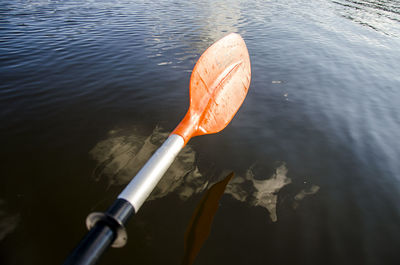 Close-up of cropped oar in rippled water