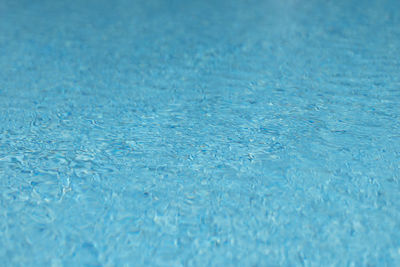 Ripple on blue water surface .