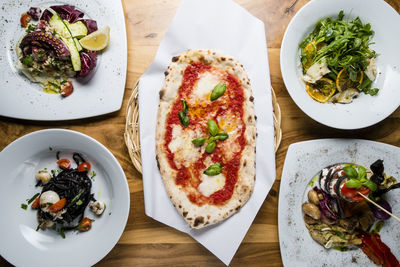 High angle view of pizza served on table