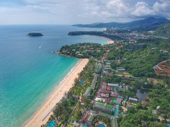 High angle view of sea and cityscape against sky