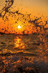 Raindrops on glass window during sunset