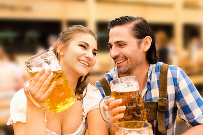 Young couple enjoying beer at restaurant