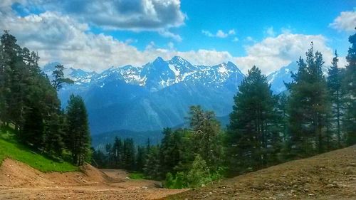 Scenic view of mountains against cloudy sky