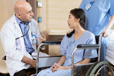 Doctor examining patient in hospital