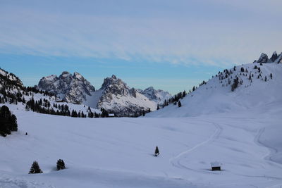 Scenic view of snow covered mountains against sky