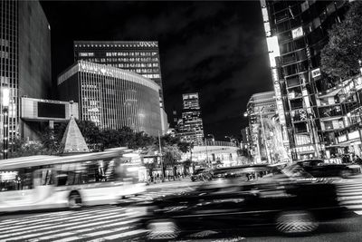 View of city street and buildings at night