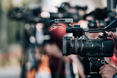 Group of cameras at an outdoor press conference