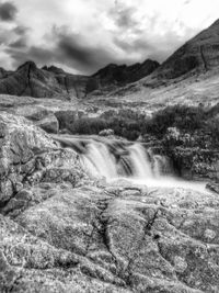 Scenic view of mountains against cloudy sky