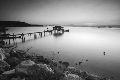 Scenic view of long pier sea against sky