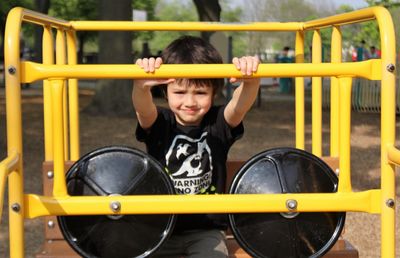 Portrait of happy boy playing in playground