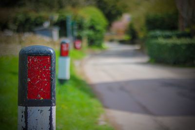 Close-up of bollards on grassy field by footpath