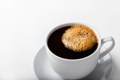 Close-up of coffee cup against white background