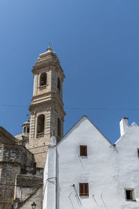 Low angle view of historic building against clear blue sky