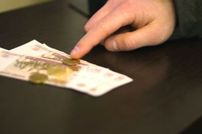 Close-up of human hand on table