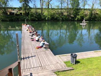 People on pier by lake