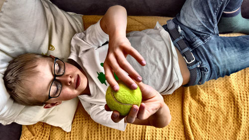 High angle view of woman lying on cutting board