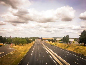 View of highway against cloudy sky