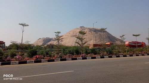 Road by city against clear sky