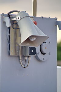 Close-up of camera hanging on wall