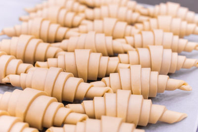 Close-up of flaky fluffy yeast raw dough for traditional french croissants on a baking sheet