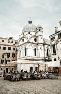 Group of people in front of buildings in city