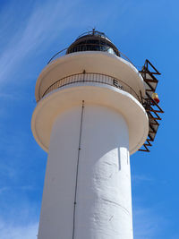 Low angle view of lighthouse against blue sky