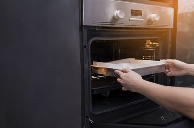 Person preparing food in microwave 