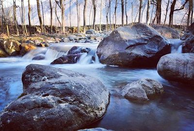 Scenic view of river flowing through rocks