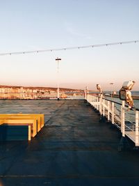 Pier over sea against clear sky