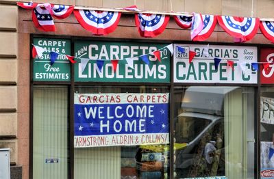 Low angle view of information sign on store