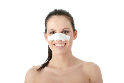 Portrait of a smiling young woman against white background