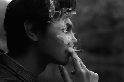 Side view of man smoking