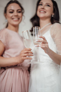 Portrait of a smiling young woman drinking glass