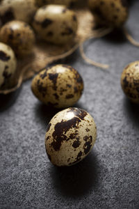 Quail eggs on a black table.