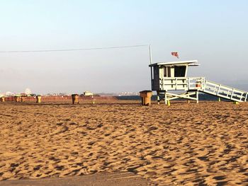 Lifeguard hut on beach against sky