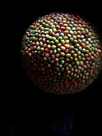 Close-up of multi colored candies against black background