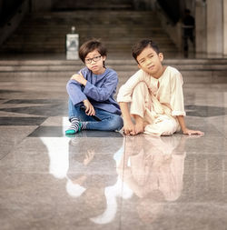 Portrait of young couple sitting on floor