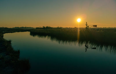 Scenic view of lake against clear sky during sunset. twiske oostzaan