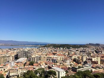 High angle view of cityscape against clear blue sky
