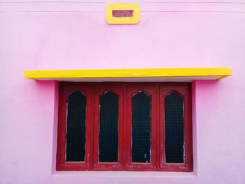 Low angle view of yellow window on building