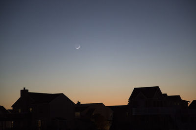 Low angle view of silhouette buildings against sky at dusk