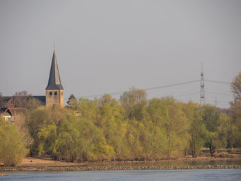 Scenic view of trees and buildings against sky