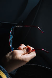 Cropped image of hand holding eyeglasses