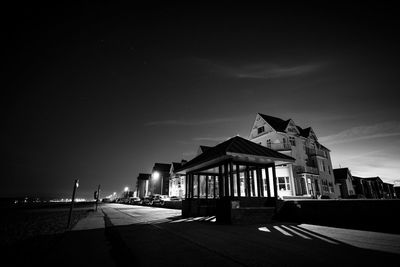 Building by street against sky at night