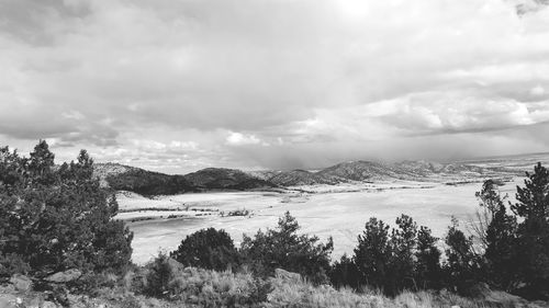 Scenic view of mountains against cloudy sky