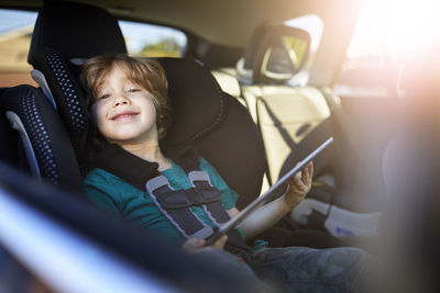 Portrait of siblings sitting in car