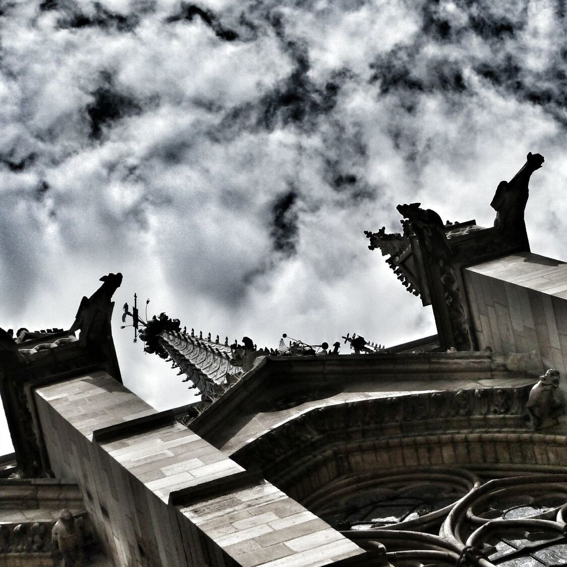 architecture, built structure, building exterior, sky, low angle view, cloud - sky, cloudy, bird, history, cloud, animal themes, overcast, famous place, place of worship, flying, day, travel destinations, religion, city, church