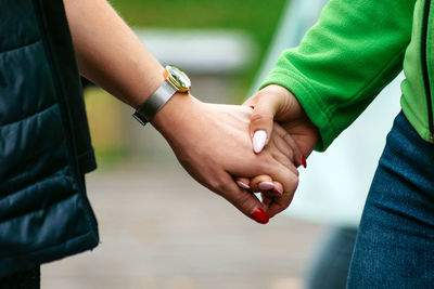 Female hands stick together in team play