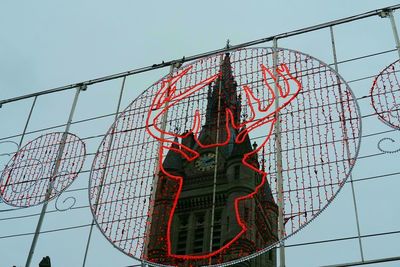 Low angle view of chainlink fence against sky