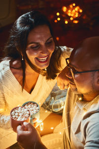 Portrait of smiling friends sitting at restaurant